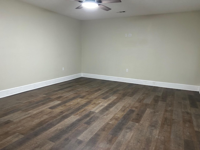 spare room with ceiling fan and dark hardwood / wood-style floors