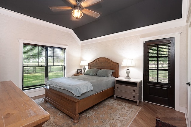 bedroom featuring ceiling fan, wood-type flooring, lofted ceiling, and multiple windows