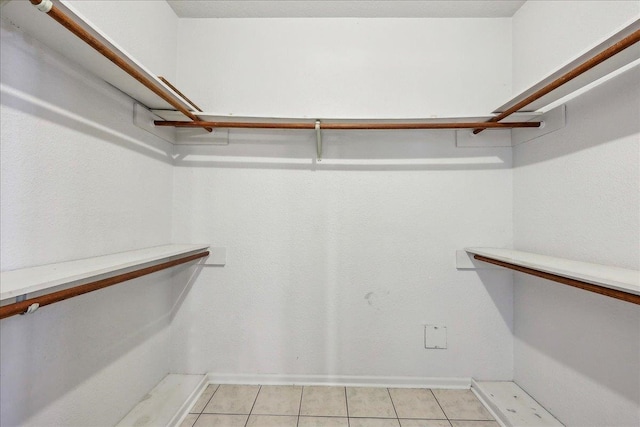 spacious closet with light tile patterned flooring