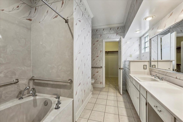 full bath featuring a washtub, a walk in closet, ornamental molding, vanity, and wallpapered walls