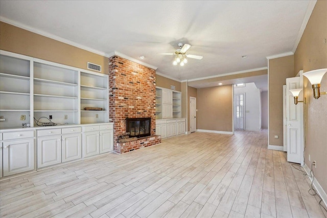 unfurnished living room with visible vents, a ceiling fan, ornamental molding, light wood-type flooring, and a brick fireplace