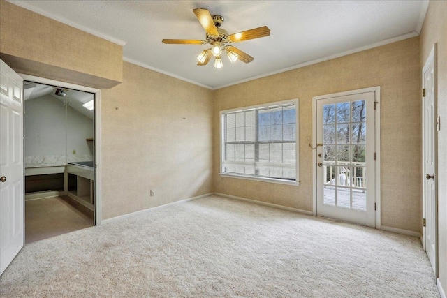 empty room with carpet, ceiling fan, and crown molding
