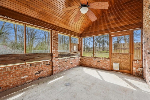 unfurnished sunroom with wooden ceiling, vaulted ceiling, and a ceiling fan