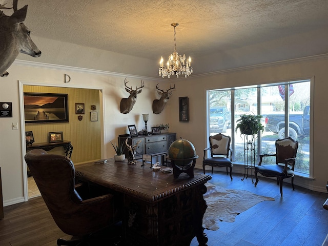 office space featuring hardwood / wood-style flooring, ornamental molding, a textured ceiling, and a chandelier