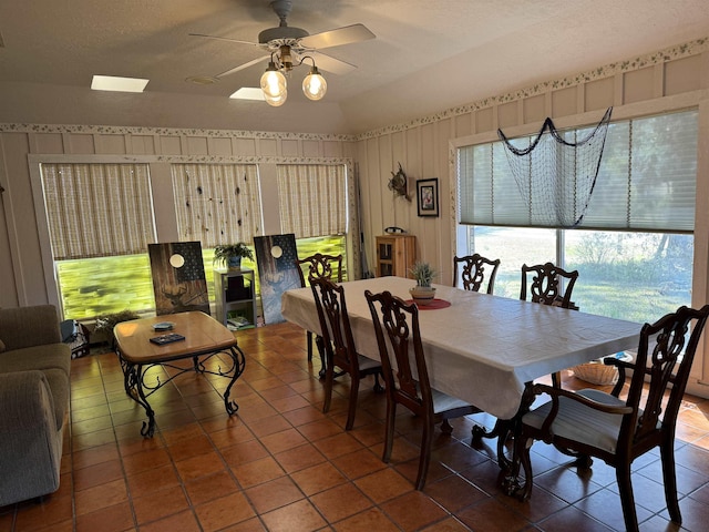 dining area featuring tile patterned flooring and ceiling fan