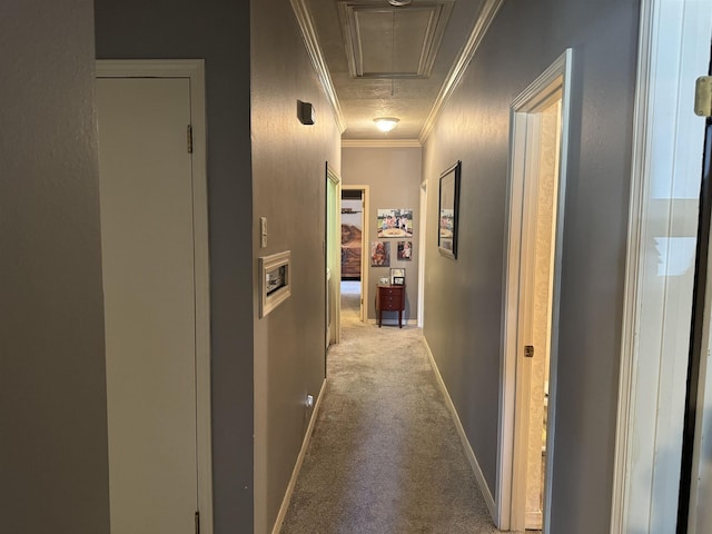 hallway with ornamental molding and light carpet