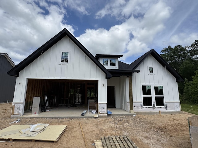 rear view of property with board and batten siding