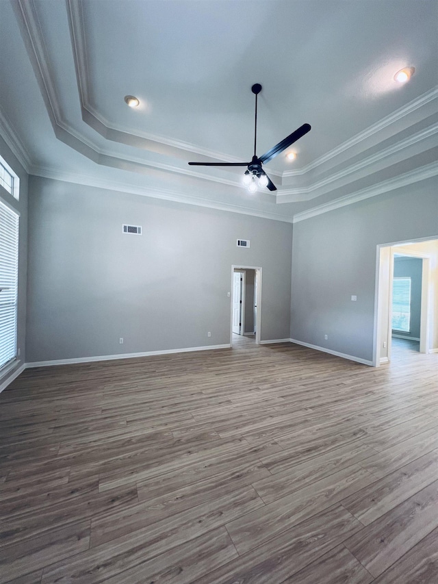 7060 Westgate Dr, Beaumont, TX 77706 - empty room with a raised ceiling, ceiling fan, wood finished floors, crown molding, and baseboards