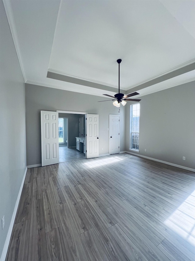 7060 Westgate Dr, Beaumont, TX 77706 - unfurnished living room with a raised ceiling, crown molding, baseboards, wood finished floors, and ceiling fan