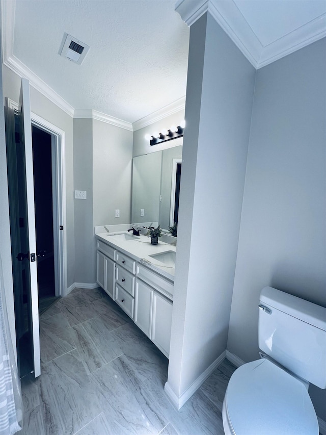7060 Westgate Dr, Beaumont, TX 77706 - bathroom featuring marble look tiles, double vanity, toilet, ornamental molding, and baseboards