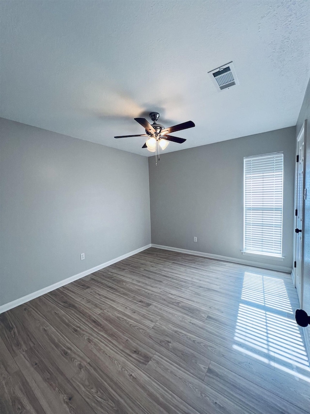 7060 Westgate Dr, Beaumont, TX 77706 - spare room featuring wood finished floors, ceiling fan, and baseboards