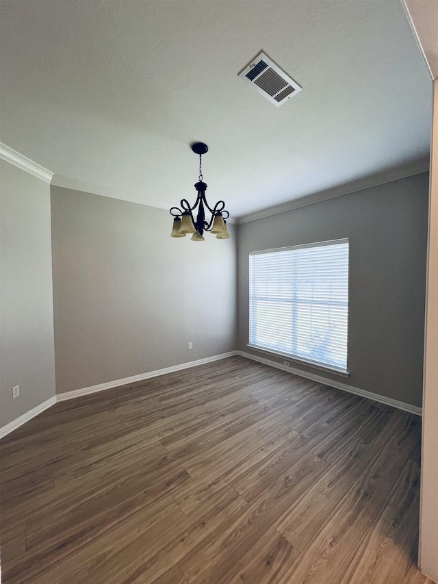 7060 Westgate Dr, Beaumont, TX 77706 - spare room with crown molding, a chandelier, baseboards, and wood finished floors