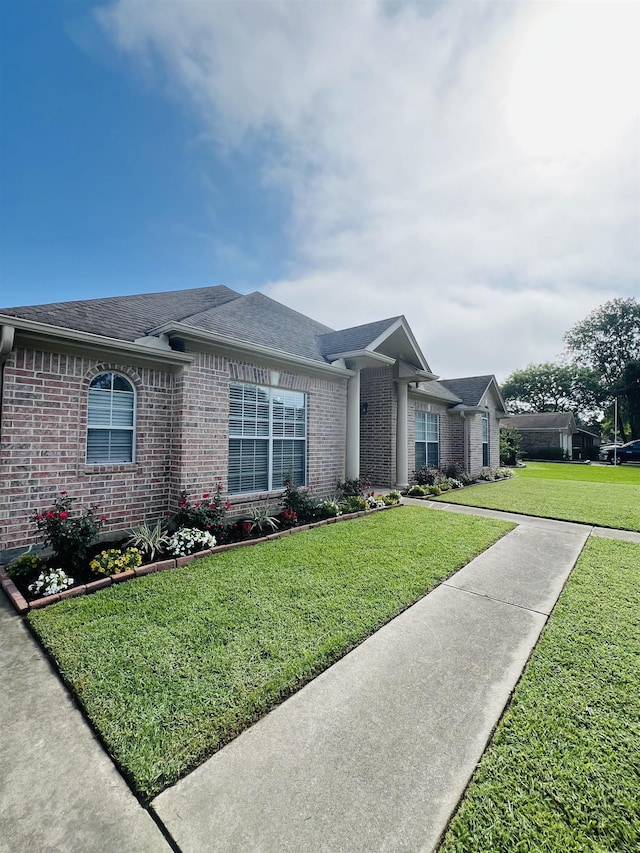 7060 Westgate Dr, Beaumont, TX 77706 - ranch-style home featuring brick siding, a front lawn, and roof with shingles