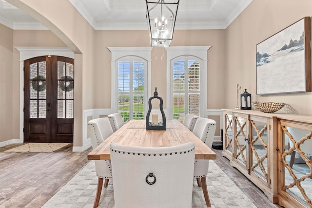 8395 Carrie Ln, Beaumont, TX 77713 - dining space with french doors, arched walkways, a chandelier, wood finished floors, and crown molding