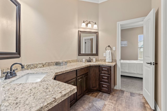 8395 Carrie Ln, Beaumont, TX 77713 - full bath with double vanity, crown molding, wood finished floors, and ensuite bathroom