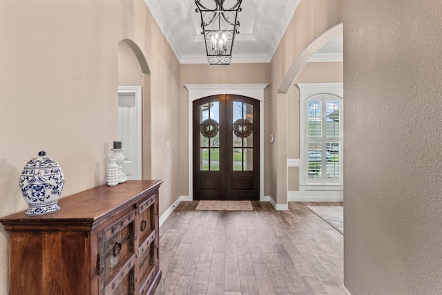 8395 Carrie Ln, Beaumont, TX 77713 - entryway with arched walkways, wood finished floors, french doors, crown molding, and a textured wall
