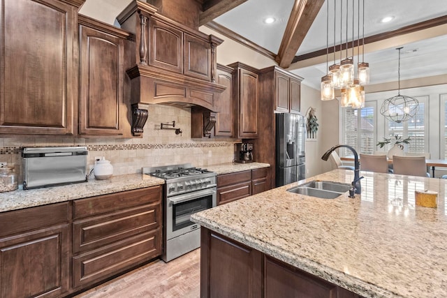 8395 Carrie Ln, Beaumont, TX 77713 - kitchen featuring appliances with stainless steel finishes, a chandelier, ornamental molding, light stone countertops, and dark brown cabinets
