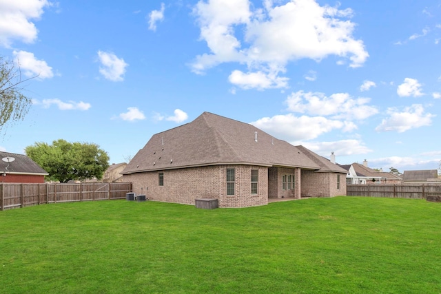 8395 Carrie Ln, Beaumont, TX 77713 - back of property with brick siding, a fenced backyard, and a shingled roof