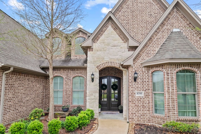 8395 Carrie Ln, Beaumont, TX 77713 - entrance to property with french doors, a shingled roof, brick siding, and stone siding