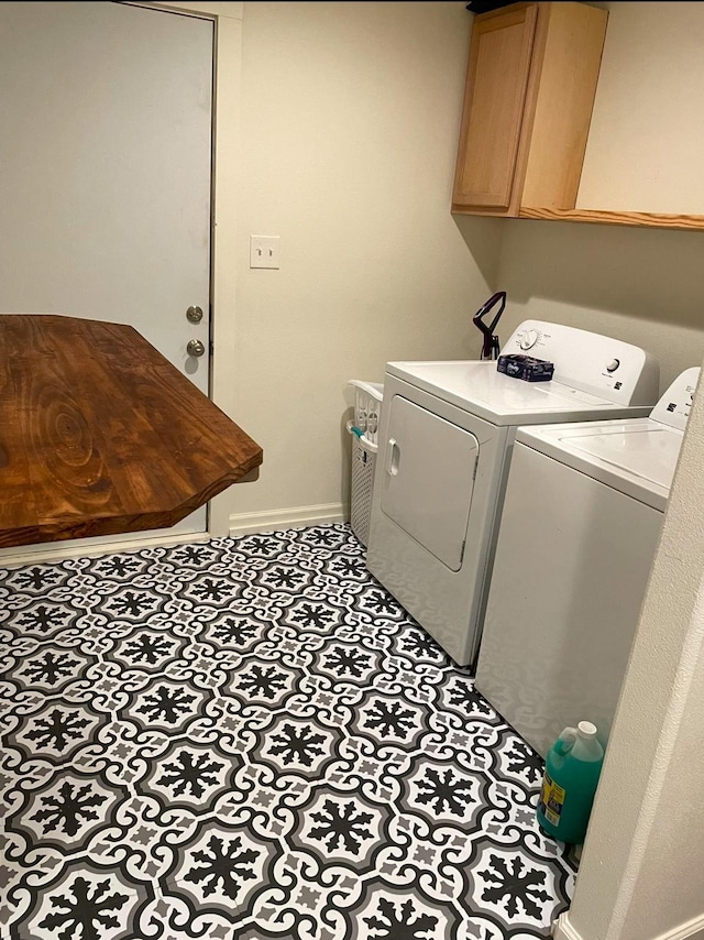 washroom with cabinets and independent washer and dryer