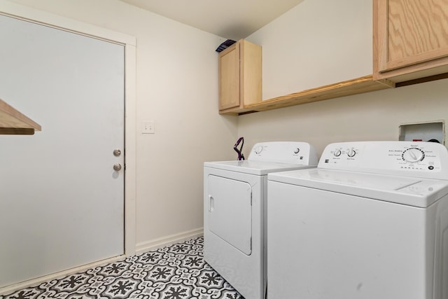 washroom with cabinets and washer and dryer
