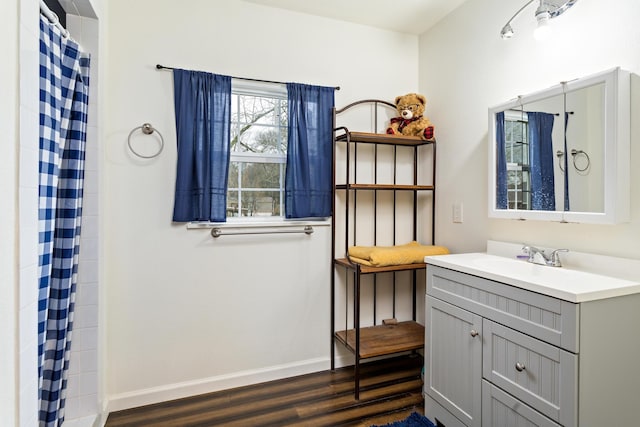 bathroom featuring hardwood / wood-style flooring, vanity, and walk in shower