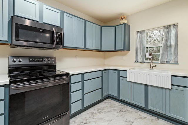 kitchen with blue cabinetry, sink, and black electric range