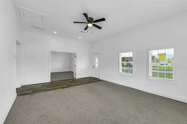 empty room featuring dark colored carpet and ceiling fan