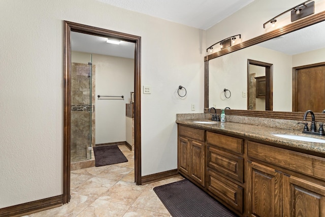 6690 Hackberry Dr, Beaumont, TX 77708 - bathroom with double vanity, tiled shower, baseboards, and tile patterned floors