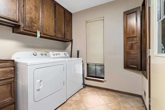 6690 Hackberry Dr, Beaumont, TX 77708 - laundry area with washer and dryer, cabinet space, baseboards, and light tile patterned floors