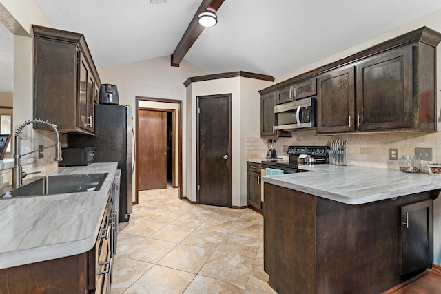 6690 Hackberry Dr, Beaumont, TX 77708 - kitchen featuring stainless steel appliances, a sink, dark brown cabinets, light countertops, and a peninsula