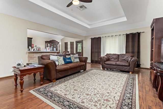 6690 Hackberry Dr, Beaumont, TX 77708 - living area featuring a ceiling fan, a tray ceiling, baseboards, and wood finished floors
