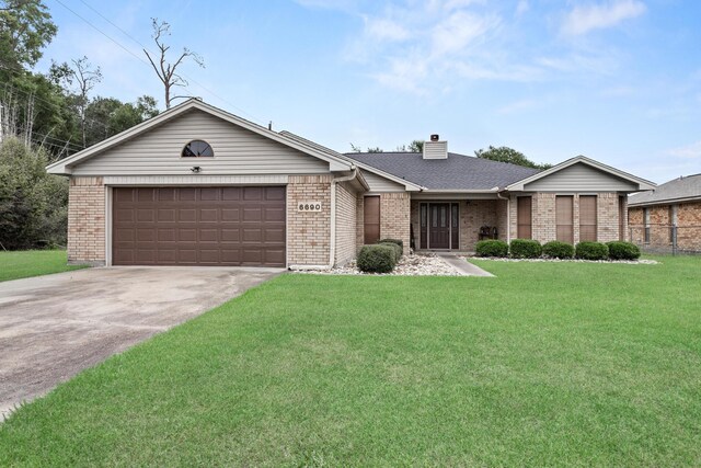 6690 Hackberry Dr, Beaumont, TX 77708 - view of front of property featuring brick siding, a chimney, an attached garage, and driveway