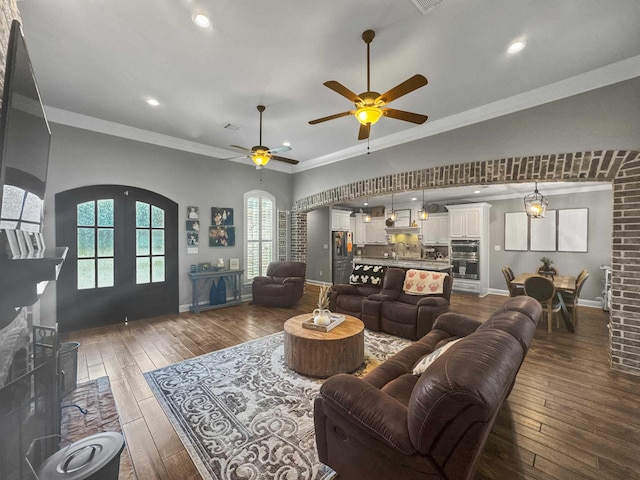 living area featuring baseboards, dark wood-style floors, ceiling fan, crown molding, and recessed lighting