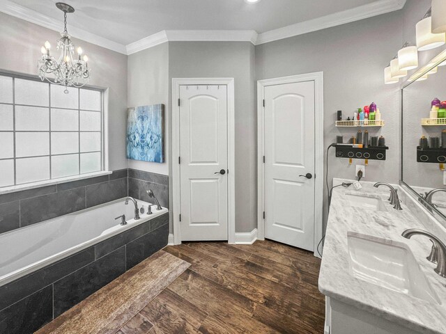 full bath with double vanity, ornamental molding, a sink, and wood finished floors