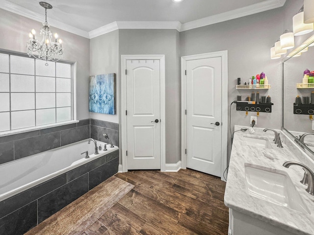 bathroom with double vanity, ornamental molding, a sink, and wood finished floors