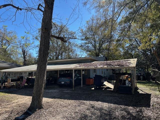 view of vehicle parking featuring a carport