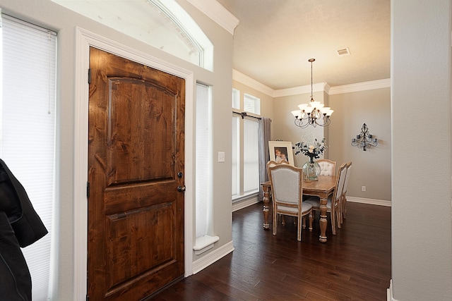 3665 Canyon Ln, Beaumont, TX 77713 - entryway with crown molding, a chandelier, and dark wood-type flooring