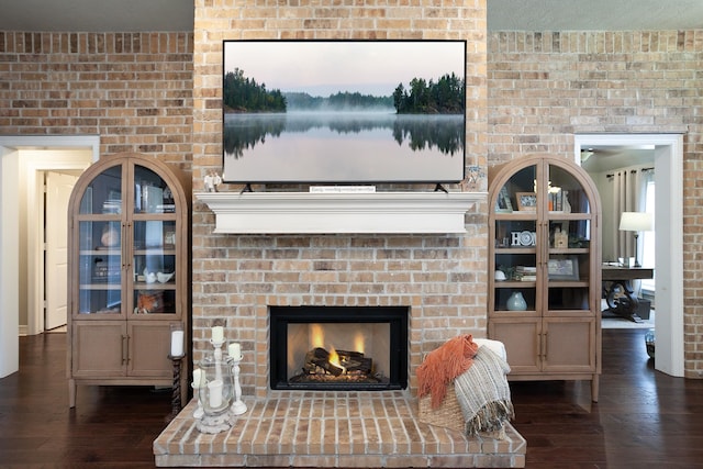 3665 Canyon Ln, Beaumont, TX 77713 - living room featuring dark wood-type flooring and a brick fireplace
