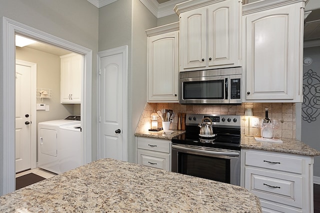 3665 Canyon Ln, Beaumont, TX 77713 - kitchen featuring stainless steel appliances, washing machine and clothes dryer, backsplash, ornamental molding, and light stone counters