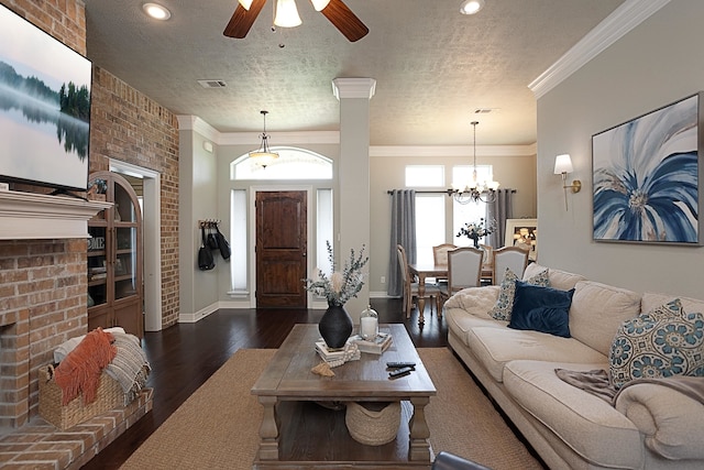 3665 Canyon Ln, Beaumont, TX 77713 - living room featuring wood finished floors, ornamental molding, a textured ceiling, a ceiling fan, and a brick fireplace
