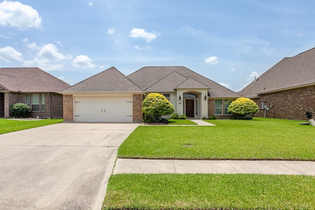 3665 Canyon Ln, Beaumont, TX 77713 - french provincial home featuring brick siding, a front yard, an attached garage, and concrete driveway