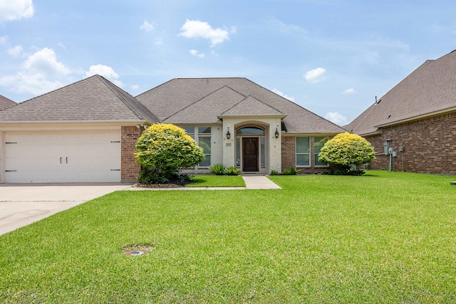 3665 Canyon Ln, Beaumont, TX 77713 - french provincial home with brick siding, a front yard, a garage, driveway, and a shingled roof