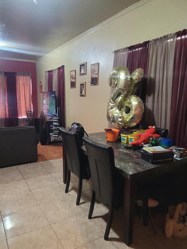 dining room with light tile patterned flooring and ornamental molding