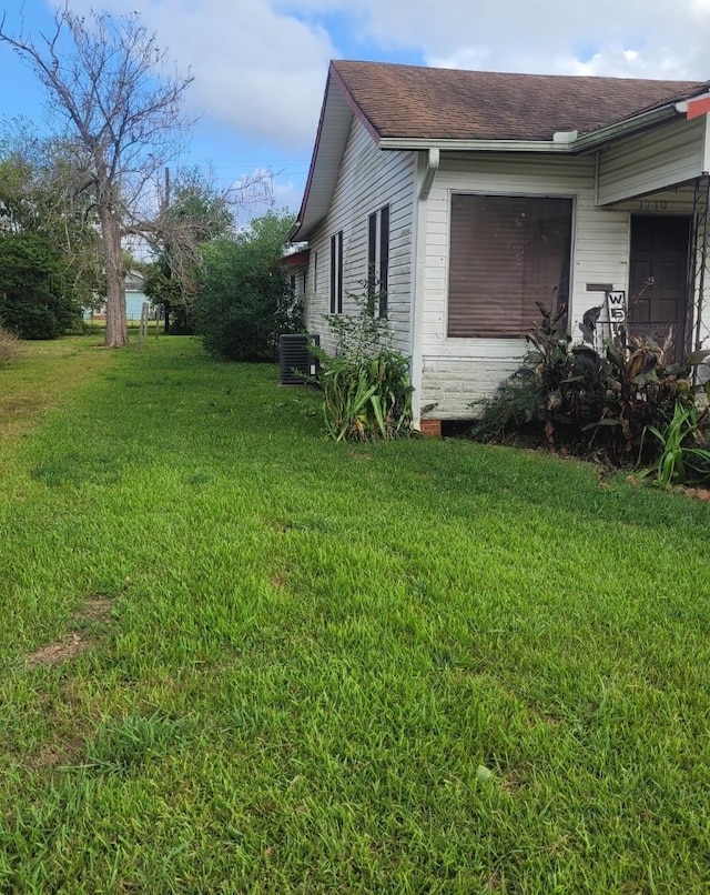 view of home's exterior featuring central AC unit and a lawn