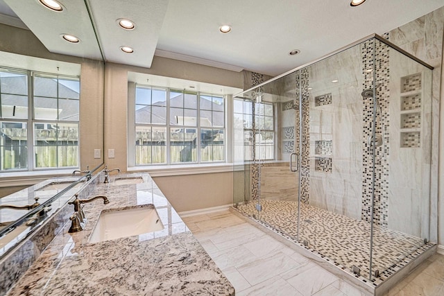 bathroom with vanity and a shower with door