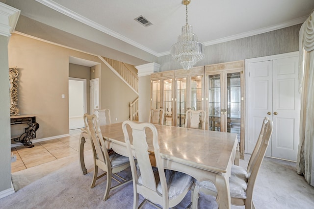 dining area featuring a chandelier, light tile patterned flooring, ornamental molding, and french doors