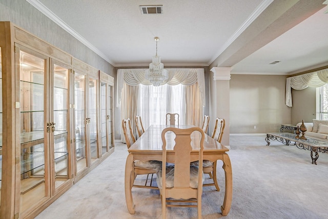 dining space with a textured ceiling, carpet floors, crown molding, and an inviting chandelier