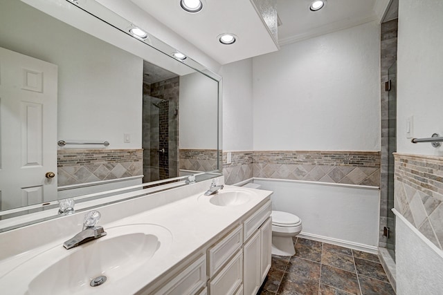 bathroom featuring crown molding, vanity, tile walls, and toilet