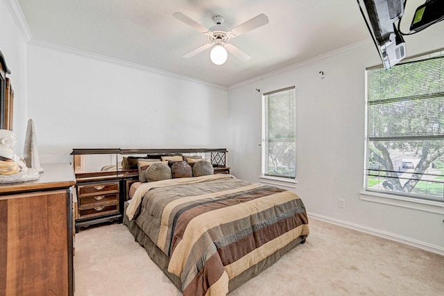 bedroom with multiple windows, light colored carpet, ceiling fan, and crown molding